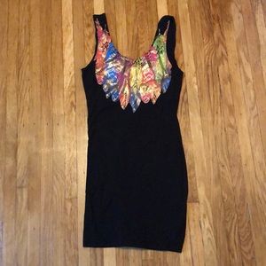 Fitted black dress with feathers around neckline